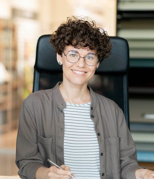 Someone smiling in chair to camera